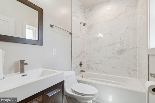 full bathroom with toilet, tiled shower / bath, and vanity