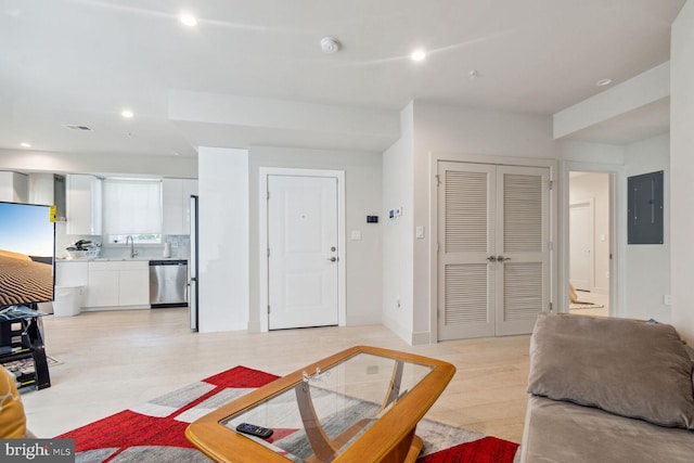 living room featuring sink and electric panel