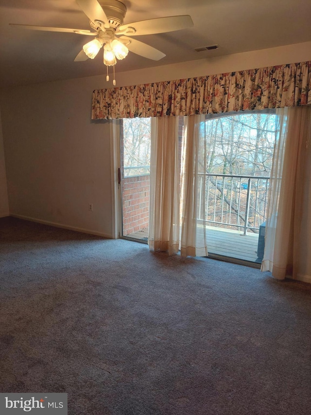 carpeted spare room with ceiling fan