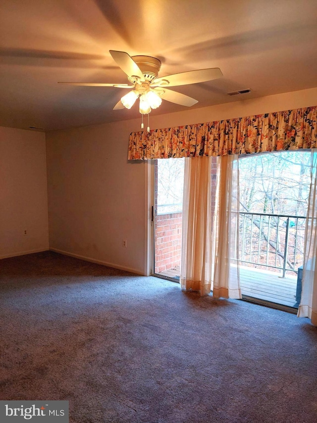 carpeted spare room with ceiling fan