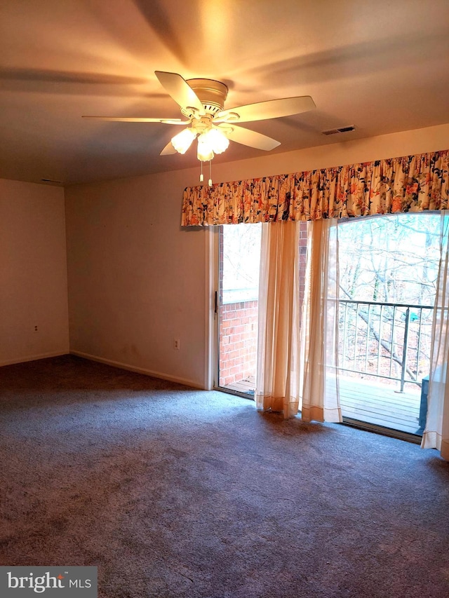 carpeted spare room with ceiling fan