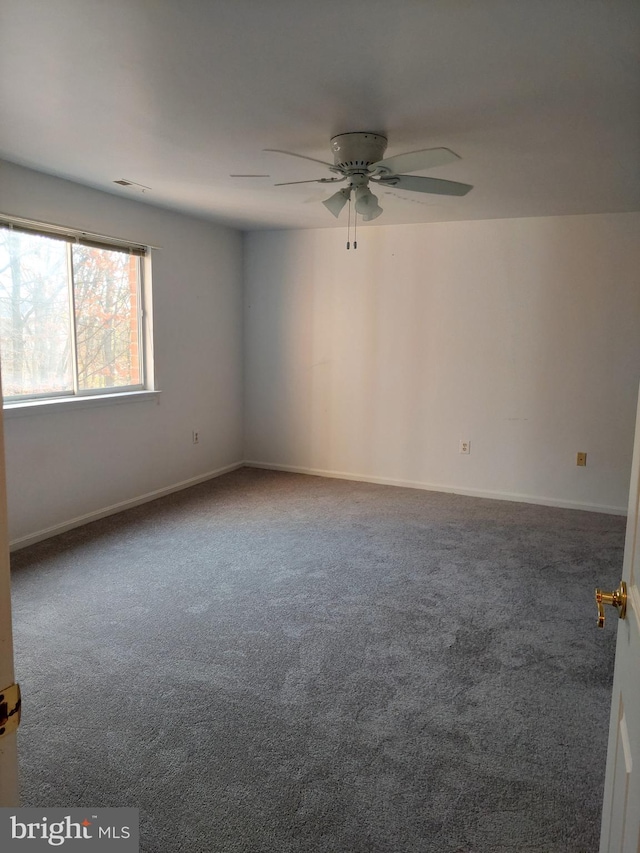 unfurnished room with ceiling fan and carpet floors