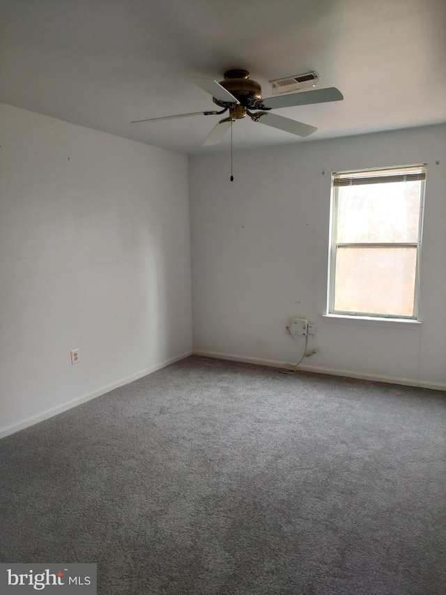 spare room with ceiling fan and carpet floors