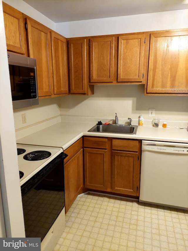 kitchen featuring white appliances and sink