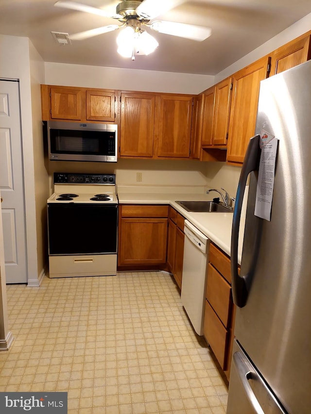 kitchen with ceiling fan, sink, and stainless steel appliances