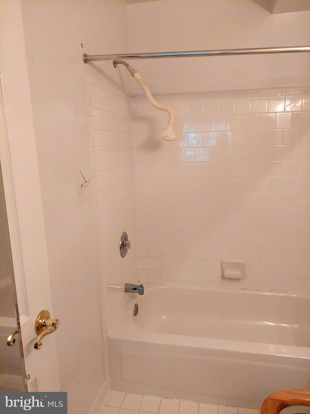 bathroom with tile patterned floors and tiled shower / bath combo