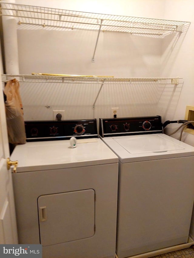 clothes washing area featuring washer and clothes dryer