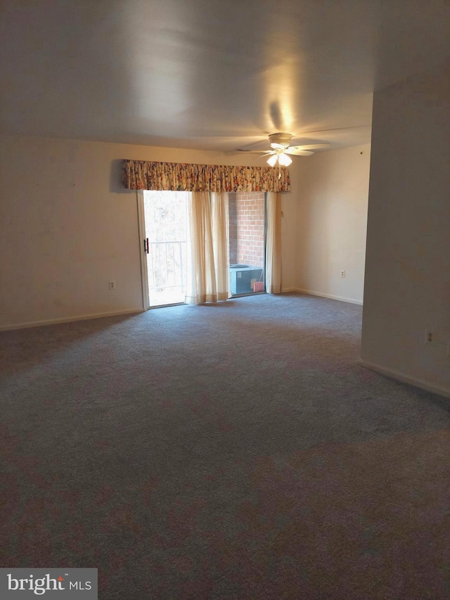 carpeted spare room featuring ceiling fan