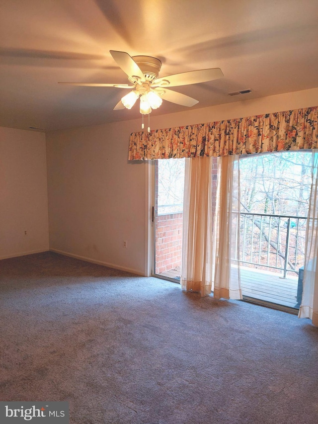 carpeted spare room with ceiling fan