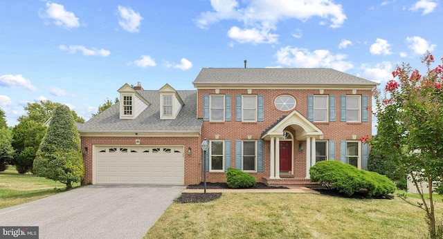 view of front of home featuring a garage and a front lawn