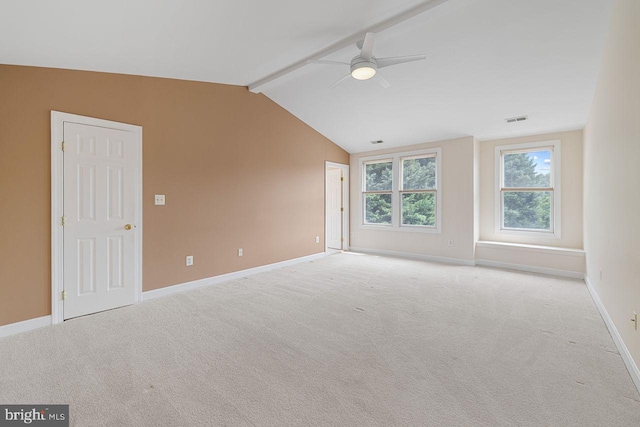 spare room with light carpet, vaulted ceiling with beams, and ceiling fan