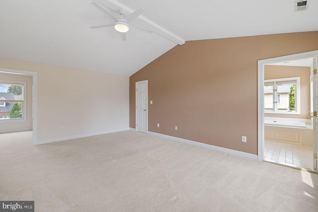 carpeted empty room featuring vaulted ceiling with beams and ceiling fan