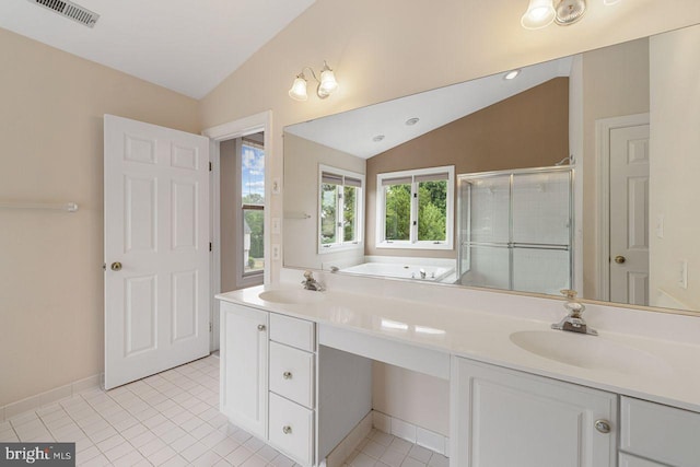 bathroom featuring tile patterned flooring, vanity, lofted ceiling, and separate shower and tub