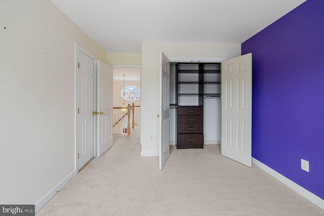 unfurnished bedroom featuring light colored carpet