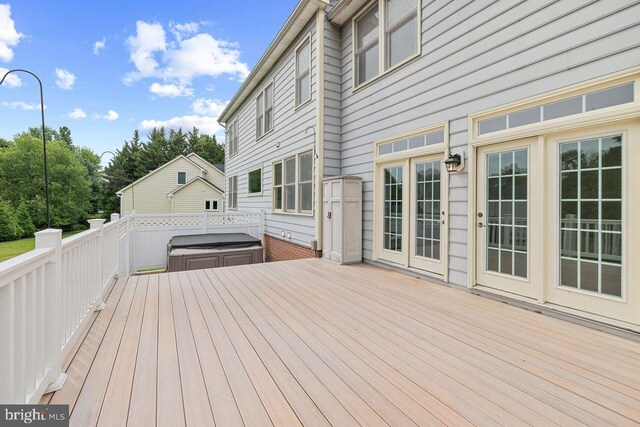 deck featuring a hot tub