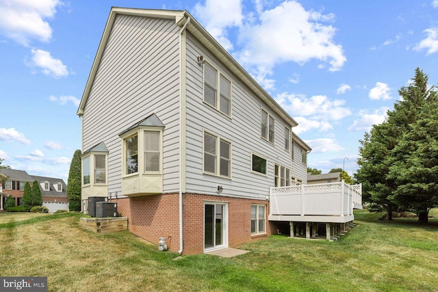 back of house featuring a wooden deck and a yard