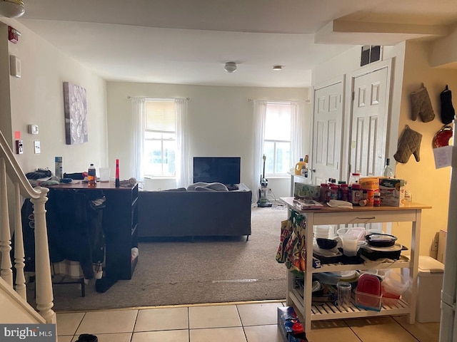 living room featuring light colored carpet and a healthy amount of sunlight