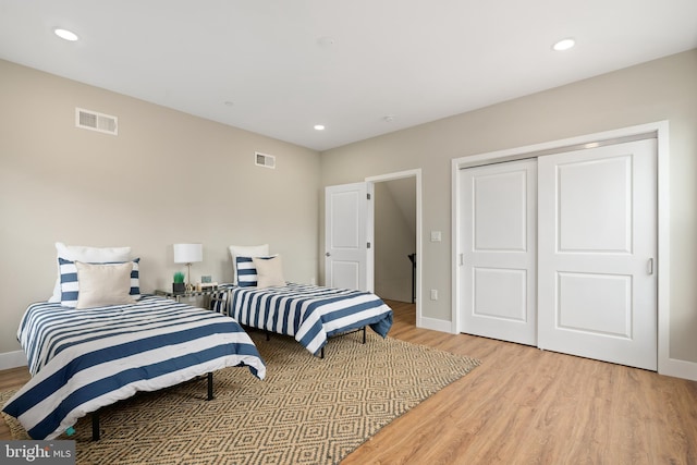 bedroom featuring a closet and light hardwood / wood-style floors