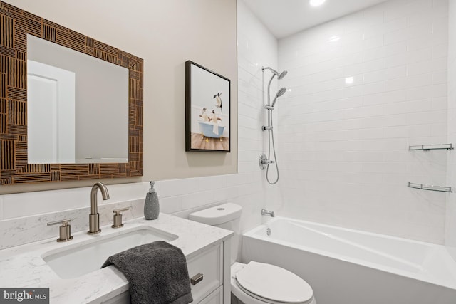 full bathroom featuring vanity, toilet, and tiled shower / bath combo