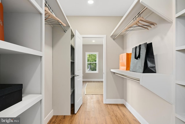 spacious closet with light hardwood / wood-style flooring