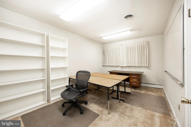 carpeted office featuring a baseboard heating unit