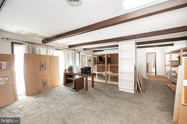 carpeted home office with beamed ceiling