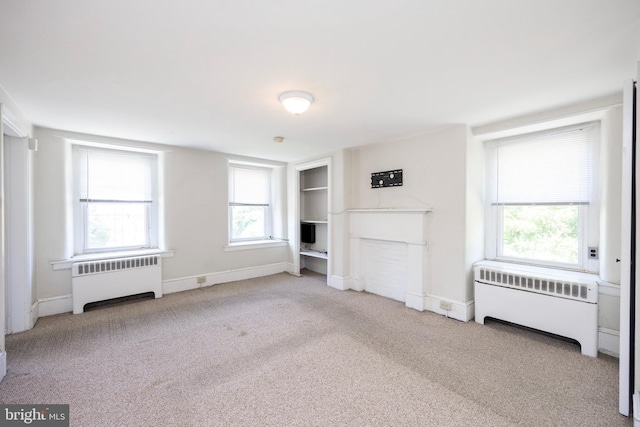 unfurnished bedroom with carpet floors and radiator