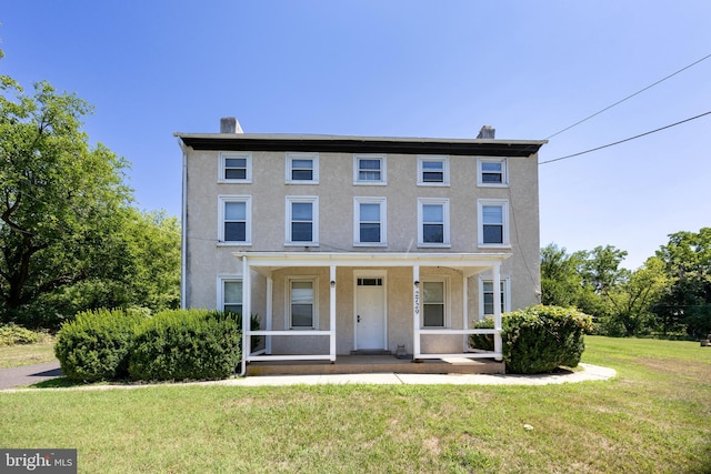 view of front facade with a porch and a front yard