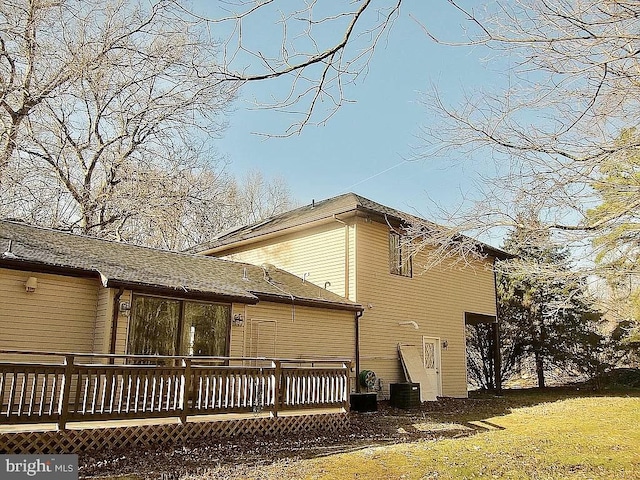 rear view of house featuring a deck and cooling unit