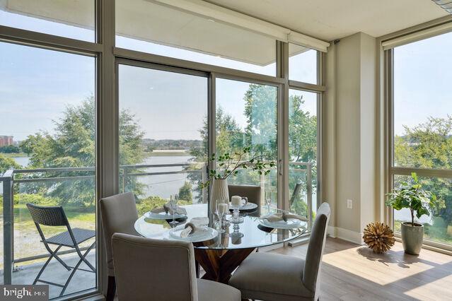 sunroom / solarium featuring plenty of natural light and a water view