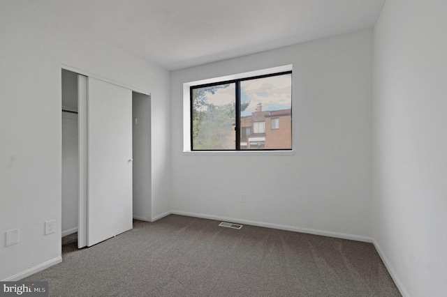 unfurnished bedroom with carpet floors and a closet