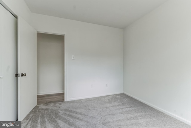 unfurnished bedroom featuring a closet and carpet floors