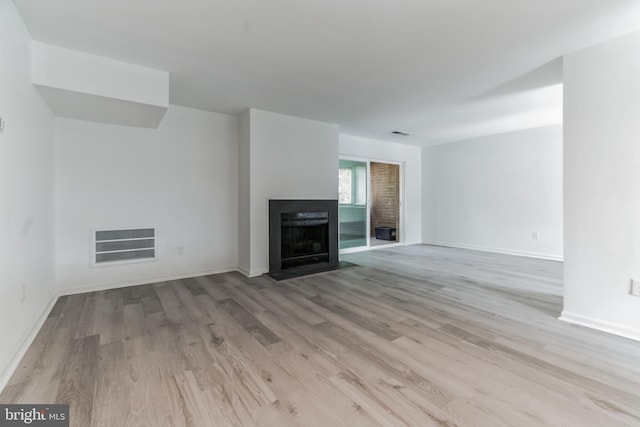 unfurnished living room with light hardwood / wood-style floors