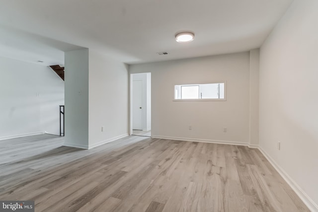 spare room featuring light wood-type flooring