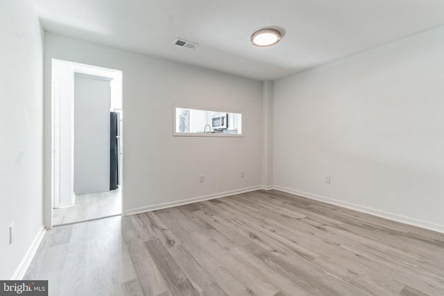 unfurnished room featuring light hardwood / wood-style flooring