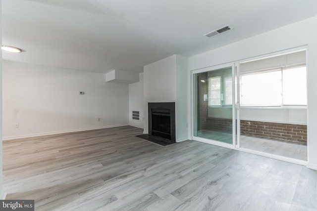 unfurnished living room featuring light wood-type flooring