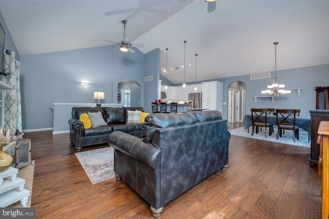 living room featuring high vaulted ceiling, ceiling fan with notable chandelier, and hardwood / wood-style flooring