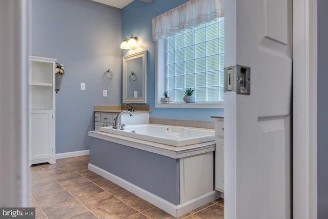 bathroom featuring a tub, tile patterned floors, vanity, and plenty of natural light