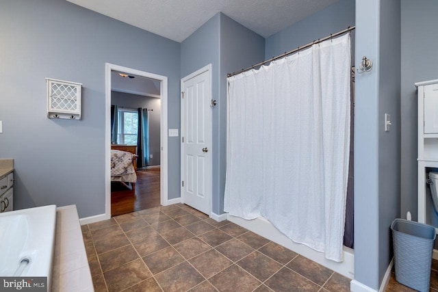 bathroom with wood-type flooring, vanity, and a textured ceiling