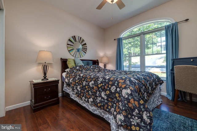 bedroom with dark hardwood / wood-style floors, lofted ceiling, and ceiling fan