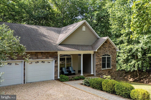 view of front property with a garage and a porch