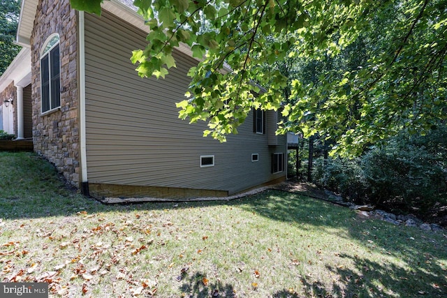 view of side of home featuring a yard