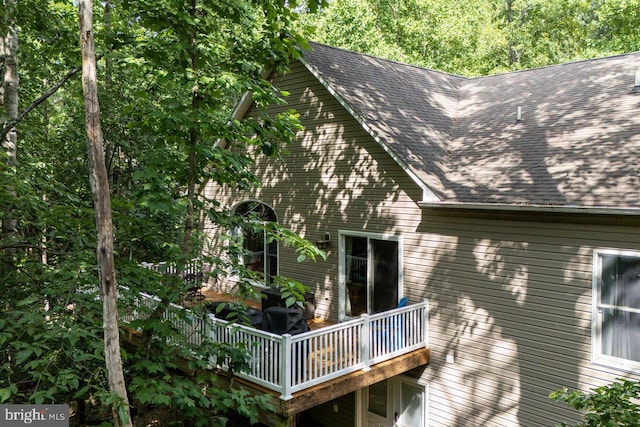 view of side of property featuring a wooden deck