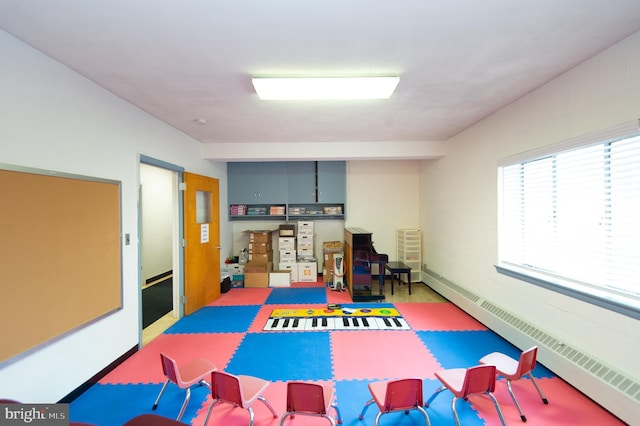 recreation room with a baseboard radiator