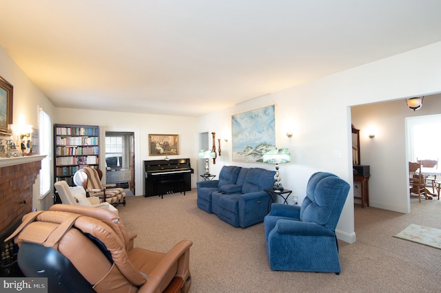 carpeted living room with a wealth of natural light and a brick fireplace