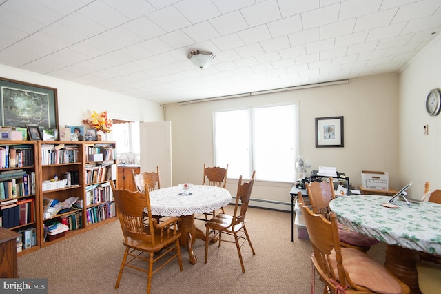 carpeted dining area featuring a baseboard radiator