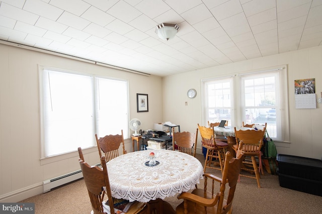 carpeted dining space featuring baseboard heating