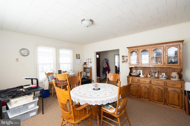 dining space with light colored carpet