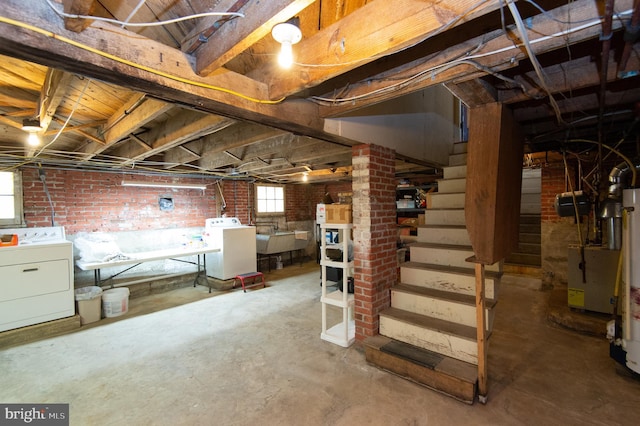 basement with washer and clothes dryer, a healthy amount of sunlight, and sink