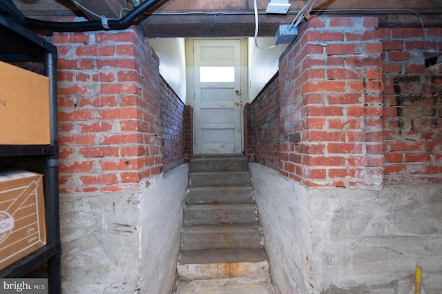 staircase with brick wall